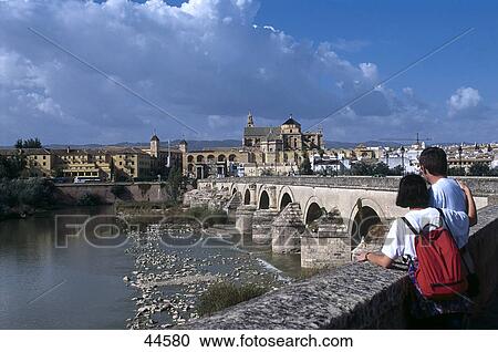 Two people looking a bridge across a river, Puente Romano, Cordoba, Roman Bridge, Andalusia, Spain View Large Photo Image Stock Image - Two people looking a bridge across a river, Puente Romano, Cordoba, Roman Bridge, Andalusia, Spain . Fotosearch