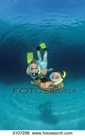Two young woman snorkeling, Bali, Indian Ocean, underwater shot View Large Photo Image Stock Photo - Two young woman snorkeling, Bali, Indian Ocean, underwater shot . Fotosearch