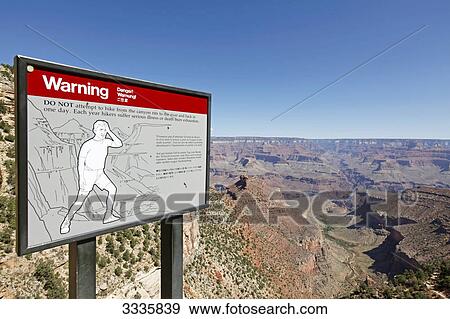 Stock Photo - Warning sign at the Bright Angel Trail, Grand Canyon South Rim, Arizona, USA . Fotosearch