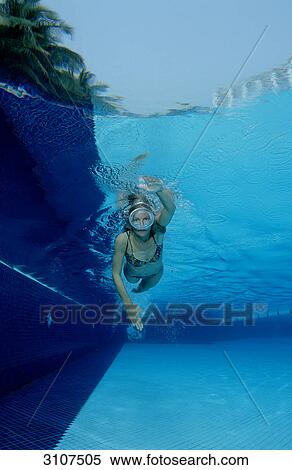 Stock Photography - Woman swimming in open-air pool, Germany, Bavaria, underwater shot . Fotosearch