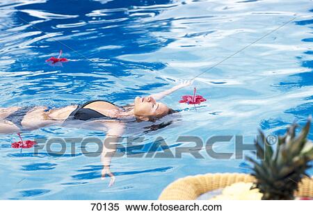 Stock Photography - Young woman swimming in a swimming pool . Fotosearch