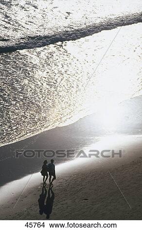Aerial view of couple walking on beach, Conil de la Frontera, Costa de la Luz, Andalucia, Spain View Large Photo Image Picture - Aerial view of couple walking on beach, Conil de la Frontera, Costa de la Luz, Andalucia, Spain . Fotosearch
