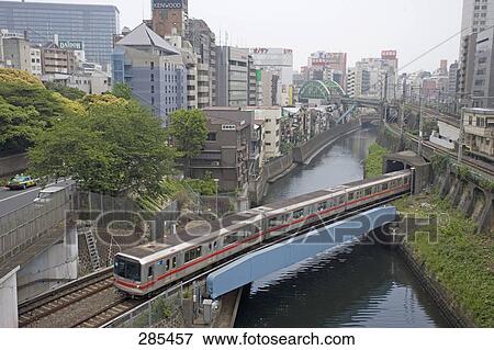 Aerial view of train crossing bridge, Tokyo Prefecture, Japan View Large Photo Image Stock Photo - Aerial view of train crossing bridge, Tokyo Prefecture, Japan . Fotosearch