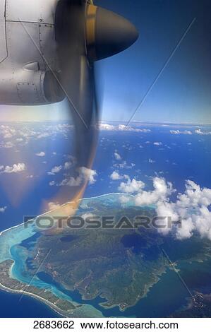 Airplane in flight, Bora Bora, Society Island, French Polynesia View Large Photo Image Stock Image - Airplane in flight, Bora Bora, Society Island, French Polynesia . Fotosearch