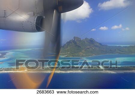 Airplane in flight, Bora Bora, Society Island, French Polynesia View Large Photo Image Stock Image - Airplane in flight, Bora Bora, Society Island, French Polynesia . Fotosearch