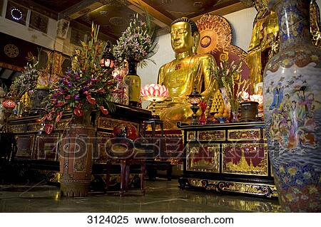 Altar with a statue of Buddha in a temple, Vietnam, low angle view View Large Photo Image Stock Photography - Altar with a statue of Buddha in a temple, Vietnam, low angle view . Fotosearch