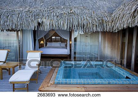 Bathtub and lounge chairs in front of hotel bedroom, Bora Bora Nui Hilton Resort, French Polynesia View Large Photo Image Stock Image - Bathtub and lounge chairs in front of hotel bedroom, Bora Bora Nui Hilton Resort, French Polynesia . Fotosearch