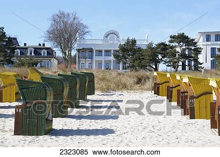 Stock Photography - Beach chairs in row in sand, Germany . Fotosearch