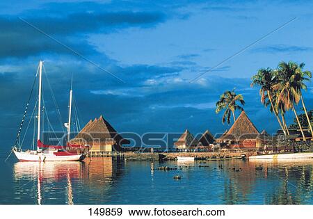 Stock Photo - Boat at a resort on the coast, Moorea, French Polynesia . Fotosearch