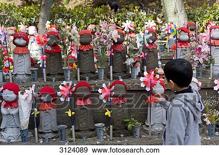 Boy standing in front of statues of Jizo at a buddhist temple, Tokyo, Japan View Large Photo Image Stock Photo - Boy standing in front of statues of Jizo at a buddhist temple, Tokyo, Japan . Fotosearch