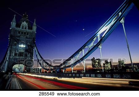 Bridge across river lit up at night, Drawbridge Tower Bridge, London, England View Large Photo Image Stock Photo - Bridge across river lit up at night, Drawbridge Tower Bridge, London, England . Fotosearch
