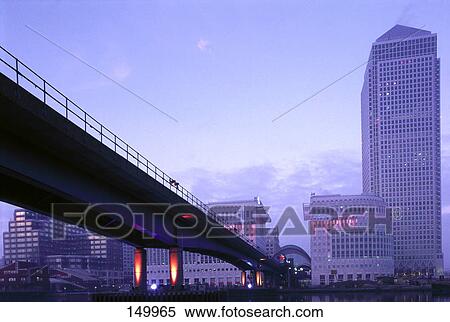 Stock Photography - Bridge with buildings in background, Canary Wharf, London, England . Fotosearch