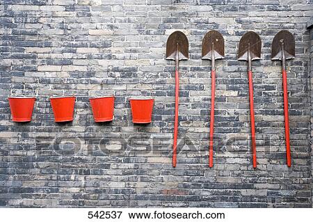 Buckets with shovels mounted on brick wall, Pingyao, Shaanxi Province, China View Large Photo Image Stock Photo - Buckets with shovels mounted on brick wall, Pingyao, Shaanxi Province, China . Fotosearch