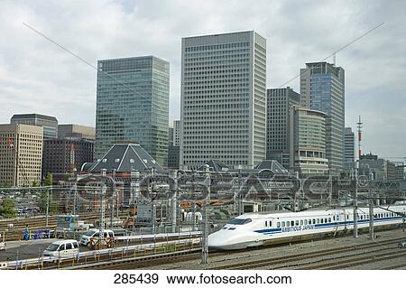 Bullet train traveling on track in city, Tokyo Prefecture, Japan View Large Photo Image Stock Photo - Bullet train traveling on track in city, Tokyo Prefecture, Japan . Fotosearch
