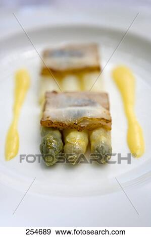 Close-up of crackers and asparagus with mustard sauce on plate View Large Photo Image Stock Photo - Close-up of crackers and asparagus with mustard sauce on plate . Fotosearch