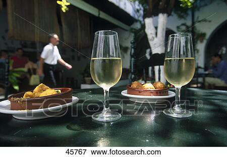 Stock Photo - Close-up of glasses of sherry and tapas on a restaurant table, Bodega Andalucia, Spain, Europe . Fotosearch