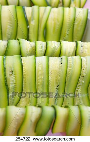 Stock Image - Close-up of slices of cucumbers . Fotosearch