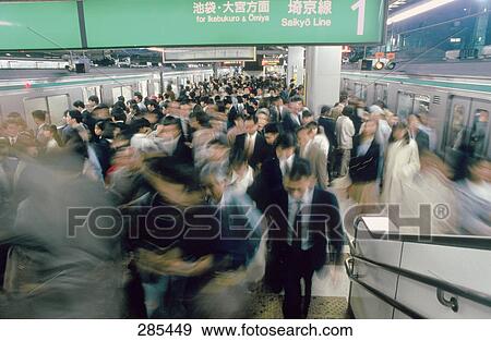 Stock Photo - Commuters hurrying on escalator in subway, Tokyo Prefecture, Japan . Fotosearch