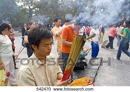 Devotees praying in temple, Lama Temple, Beijing, China View Large Photo Image Stock Image - Devotees praying in temple, Lama Temple, Beijing, China . Fotosearch