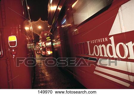 Double-decker buses on road at night, London, England View Large Photo Image Stock Image - Double-decker buses on road at night, London, England . Fotosearch