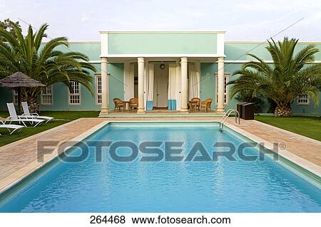 Stock Photo - Empty lounge chairs beside swimming pool, Algarve, Portugal . Fotosearch