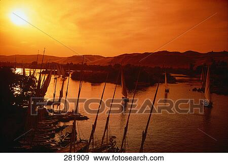 Felucca boats in river at dusk, Nile River, Aswan, Egypt View Large Photo Image Stock Photo - Felucca boats in river at dusk, Nile River, Aswan, Egypt . Fotosearch