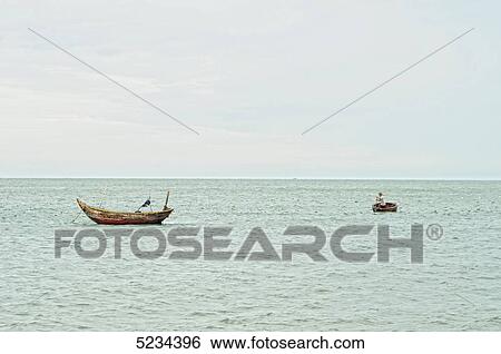 Stock Photograph - Fisherman in boat, South Chinese Ocean, Mui Ne, Vietnam, Asia . Fotosearch