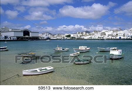 Fishing boats moored in sea, Lanzarote, Canary Islands, Spain View Large Photo Image Stock Image - Fishing boats moored in sea, Lanzarote, Canary Islands, Spain . Fotosearch