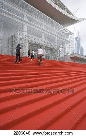 Four people climbing stairs of building View Large Photo Image Stock Photo - Four people climbing stairs of building . Fotosearch