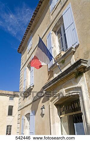 Stock Photograph - French flag in front of house, Menerbes, Luberon, Vaucluse, Provence-Alpes-Cote d'Azur, France . Fotosearch