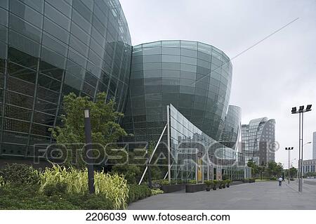 Glass buildings against overcast sky View Large Photo Image Stock Photo - Glass buildings against overcast sky . Fotosearch