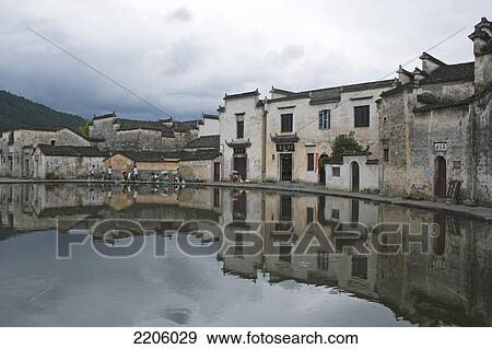 Group of people in front of houses at waterfront, Hongcun, Anhui, China View Large Photo Image Stock Photo - Group of people in front of houses at waterfront, Hongcun, Anhui, China . Fotosearch