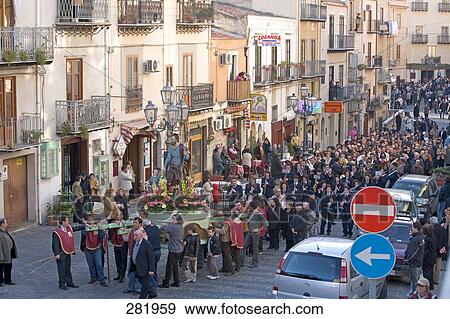 Stock Photo - Group of people participating in religious procession, Cefalu, Italy . Fotosearch