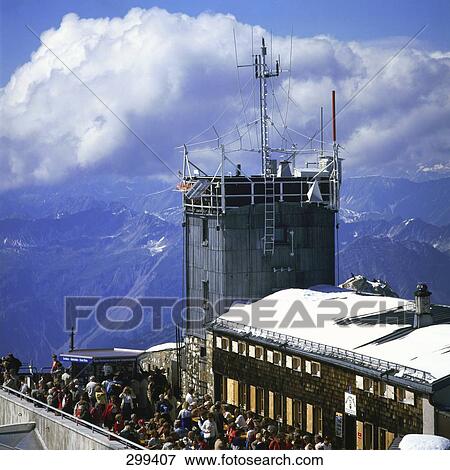 Stock Photo - Group of tourists near meteorological station at summit of mountain . Fotosearch