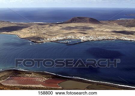 Stock Image - High angle view of a coastline, La Graciosa Island, Lanzarote, Canary islands, Spain . Fotosearch