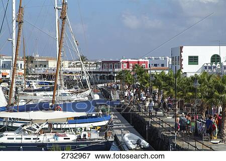 High angle view of boats and people at harbor, Marina Rubicon, Playa Blanca, Lanzarote, Canary Islands, Spain View Large Photo Image Stock Photo - High angle view of boats and people at harbor, Marina Rubicon, Playa Blanca, Lanzarote, Canary Islands, Spain . Fotosearch