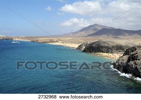 High angle view of coastline, Playas De Papagayo, Lanzarote, Canary Islands, Spain View Large Photo Image Stock Photo - High angle view of coastline, Playas De Papagayo, Lanzarote, Canary Islands, Spain . Fotosearch
