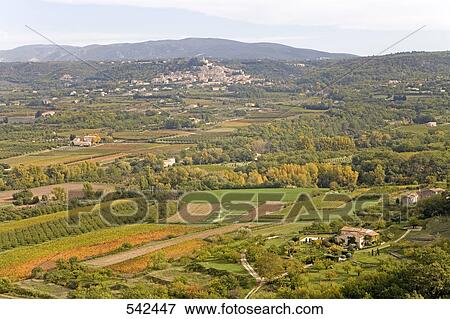 High angle view of fields with village in background, Lacoste, Luberon, Vaucluse, Provence-Alpes-Cote d'Azur, France View Large Photo Image Stock Photo - High angle view of fields with village in background, Lacoste, Luberon, Vaucluse, Provence-Alpes-Cote d'Azur, France . Fotosearch