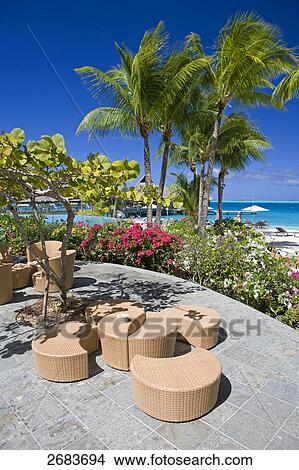 High angle view of table and chairs in resort's garden, Bora Bora Nui Hilton Resort, French Polynesia View Large Photo Image Picture - High angle view of table and chairs in resort's garden, Bora Bora Nui Hilton Resort, French Polynesia . Fotosearch