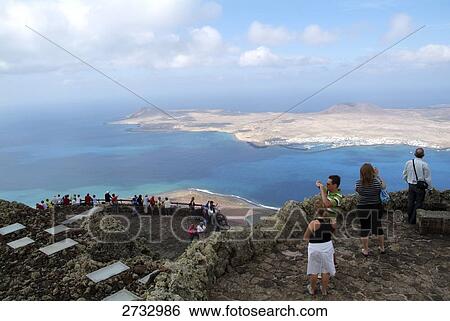 High angle view of tourists standing at observation point, Lanzarote, Canary Islands, Spain View Large Photo Image Stock Photograph - High angle view of tourists standing at observation point, Lanzarote, Canary Islands, Spain . Fotosearch