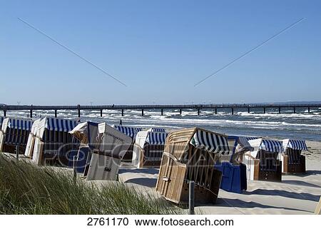 Stock Image - Hooded beach chairs on beach, Ostseebad Binz, Ruegen, Mecklenburg-Western Pomerania, Germany . Fotosearch