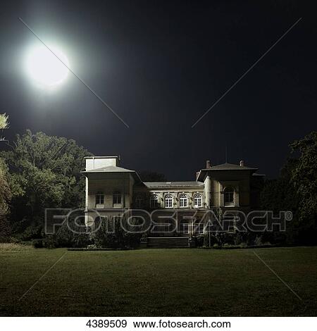 Stock Photo - House at full moon . Fotosearch