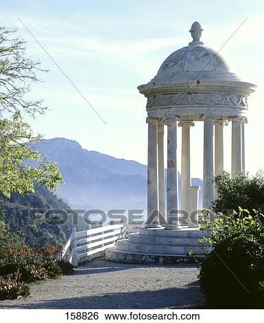 Stock Photograph - Ionic temple with mountain in background, Son Marroig, Majorca, Balearic Islands, Spain . Fotosearch