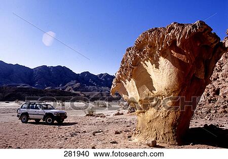 Jeep parked near rock formations in desert, Egypt View Large Photo Image Stock Image - Jeep parked near rock formations in desert, Egypt . Fotosearch