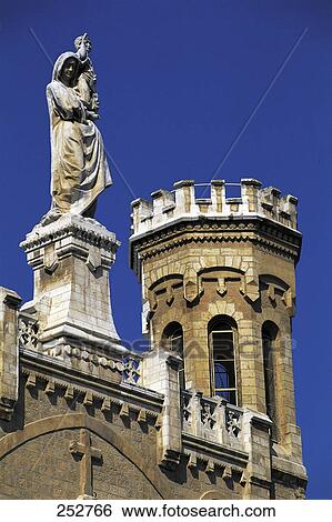 Jesus statue on top of church against blue sky View Large Photo Image Stock Photograph - Jesus statue on top of church against blue sky . Fotosearch