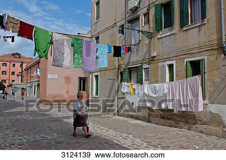 Stock Photo - Laundry drying on clotheslines in an alley, Giudecca, Venice, Italy . Fotosearch