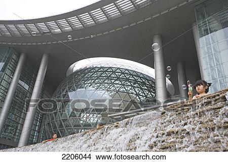 Low angle view of children near artificial waterfall in modern building View Large Photo Image Picture - Low angle view of children near artificial waterfall in modern building . Fotosearch
