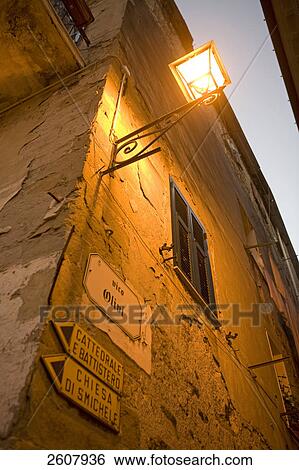 Low angle view of lamp lit up on wall, Italy View Large Photo Image Stock Photograph - Low angle view of lamp lit up on wall, Italy . Fotosearch