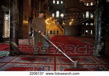 Stock Photo - Man cleaning carpets inside mosque, Blue Mosque, Istanbul, Turkey . Fotosearch