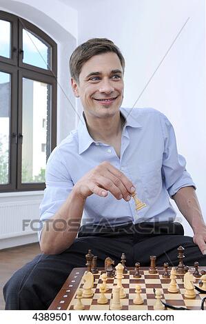 Stock Image - Man playing chess . Fotosearch
